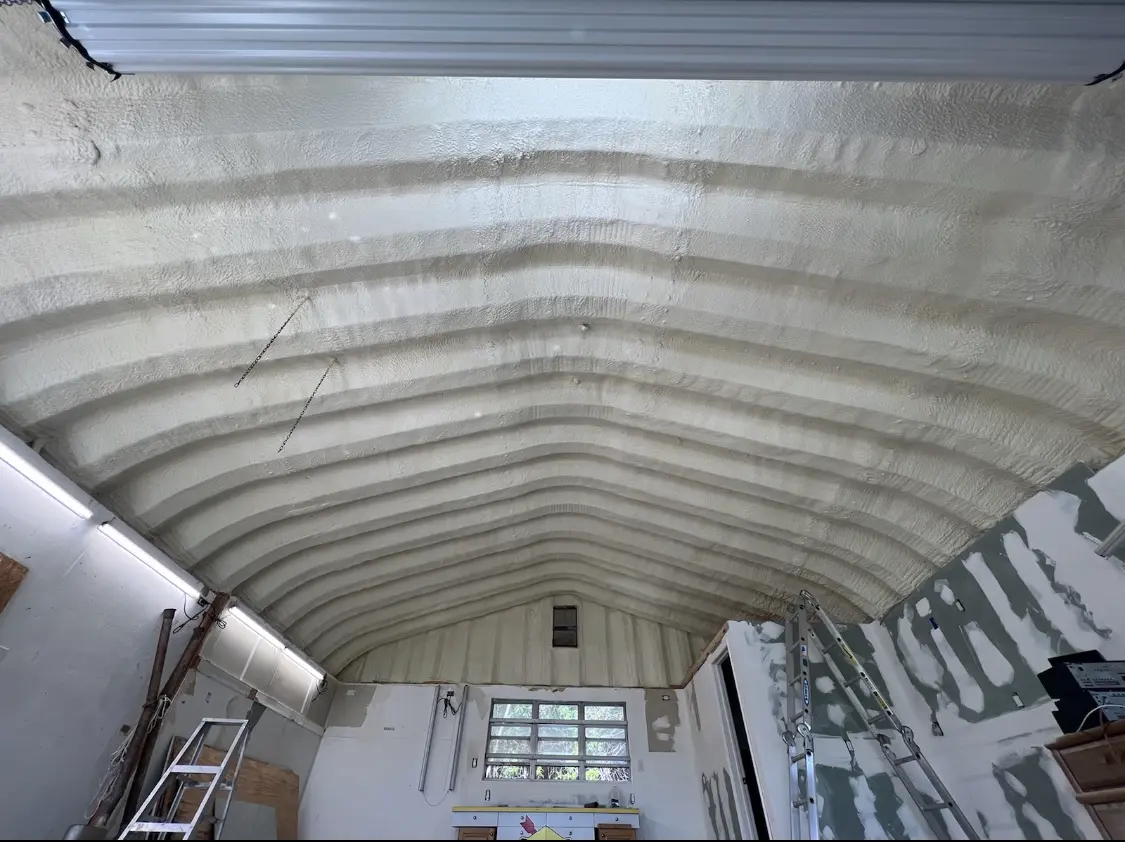 Spray polyurethane foam applied to the underside of a metal roof deck in Northport